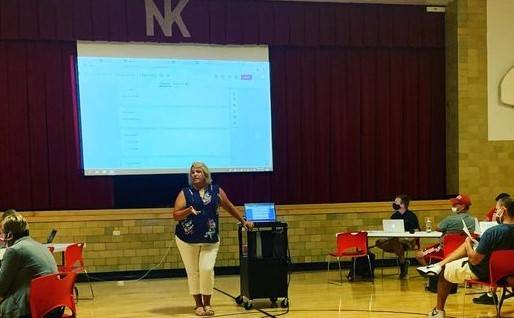 Woman speaking to staff in a school district