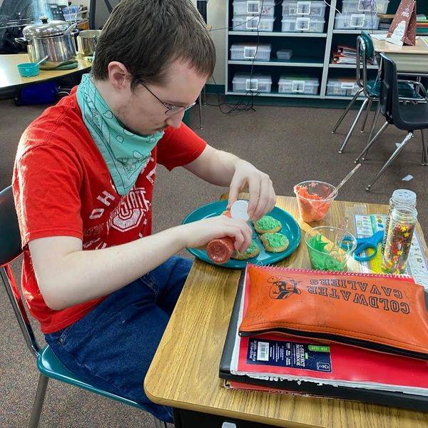 Student making Christmas cookies.