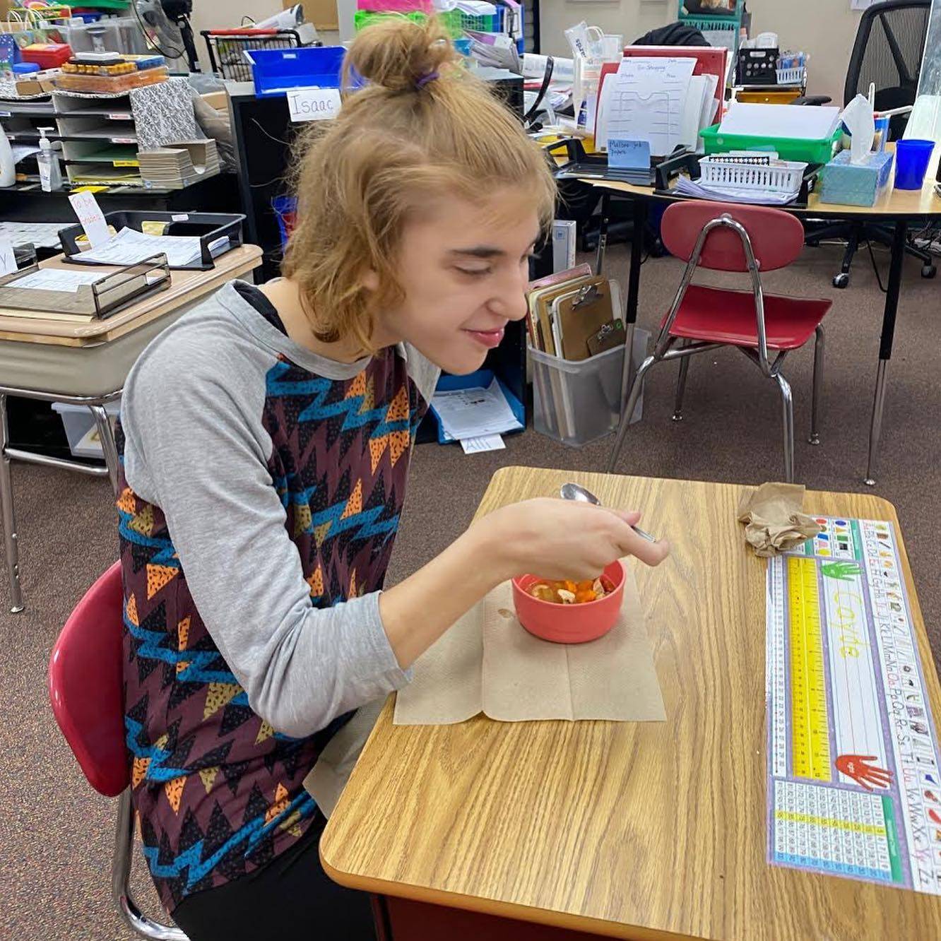 Student eating soup.